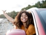 <p>Mujer viajando en auto sonriendo</p>